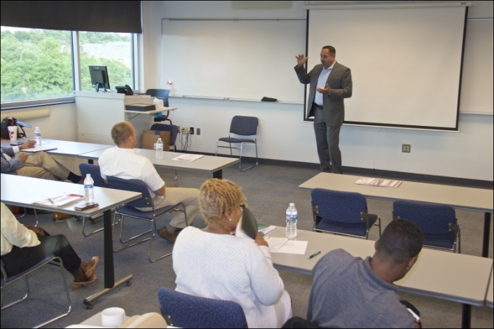 Jimmy Maldonado, COE and Founder Helios Defense Solutions and Anne Arundel Fall 2014 Class Graduate addressing the graduating class and guests