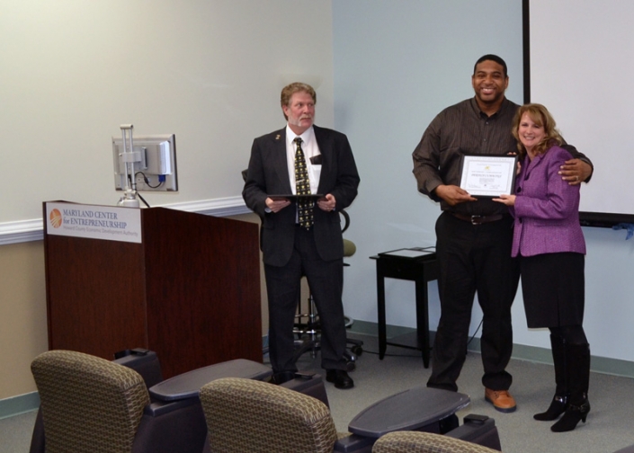 Derich Cummings receiving his Certificate of Completion from Brenda Dilts, course instructor