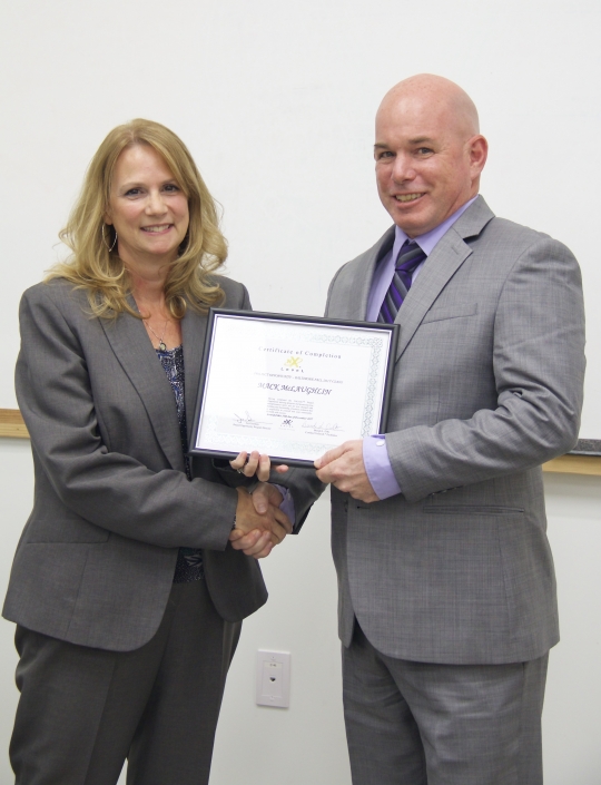 Brenda Dilts, Course Facilitator, presenting Graduation Certificate to Mack McLaughlin