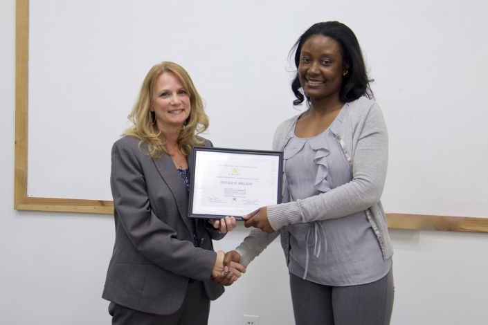 Brenda Dilts, Course Facilitator, presenting Graduation Certificate to Nicole P. Nelson