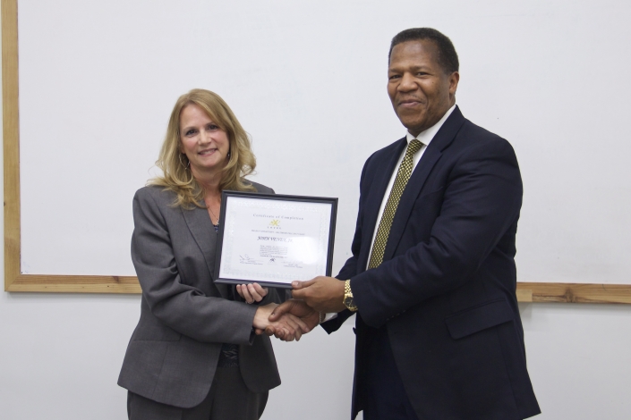 Brenda Dilts, Course Facilitator, presenting Graduation Certificate to John Veney, Jr.