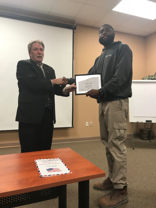 Pierre Gore receiving Certificate of Completion