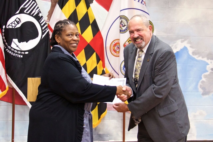 Secretary Owings presenting Completion Certificate to Bridgette M. Alfred