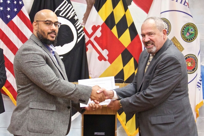 Secretary Owings presenting Completion Certificate to Ernest Duane Black