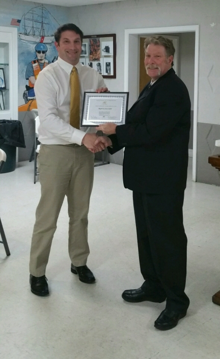 Joe Giordano presenting Certificate of Completion to Travis Julyan