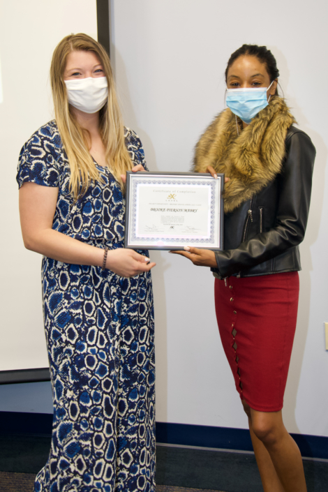 Tiffany Davis Course Facilitator presenting Graduation Certificate to Erika L Brown