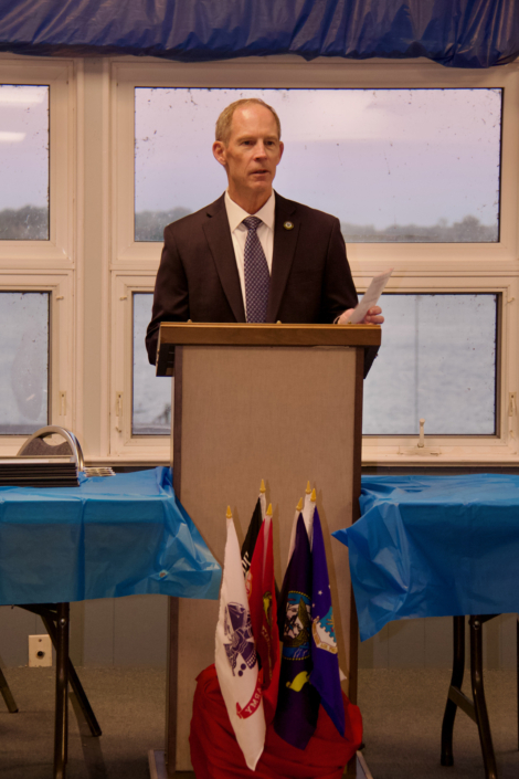 Bob Brown, Mentoring Program Coordinator, addressing graduates, mentors, and guests