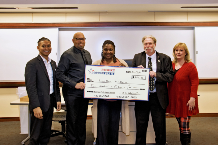 Check Presentation to Lori Crawford, 3rd Place Business Pitch Left to Right: Emmyrich Vicente (PNC Bank and Business Pitch Judge); Anthony Butler Sr. Course Facilitator; Joanna Starling; Joe Giordano Project Opportunity<sup>SM</sup> Founder, and Kim McGettigan (Montgomery College and Business Pitch Judge)