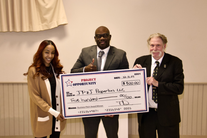 Check presentation to Olan Adeyemo 2nd Place Winner in Business Pitch Competition